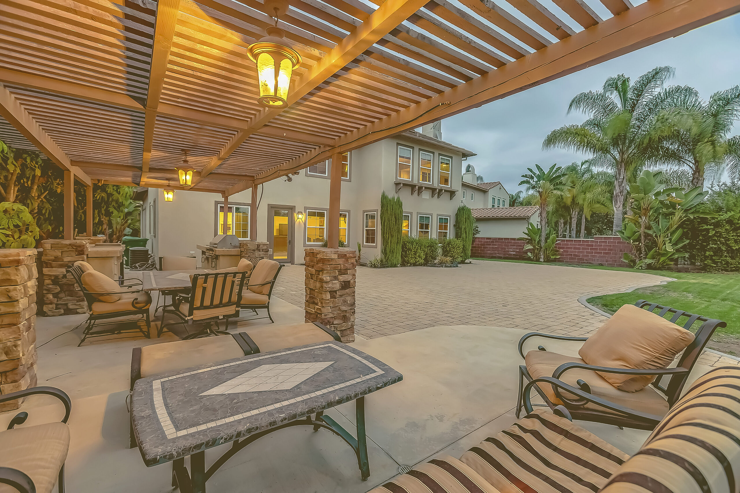 Outdoor Dining Area Under A Wooden Pergola On The Patio Of A Hou Outdoor dining area under a wooden pergola on the patio of a house